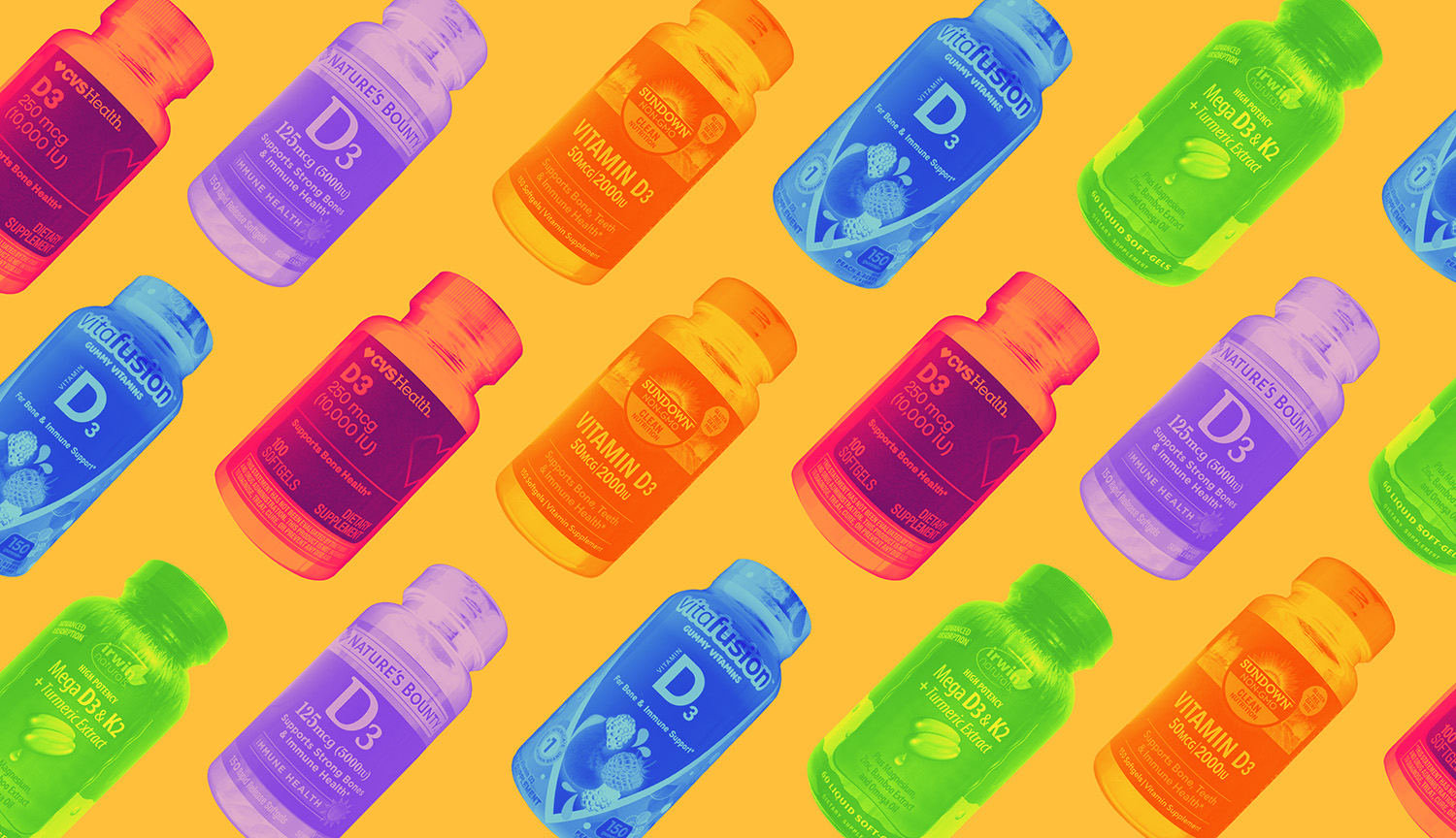 An array of bottles of vitamin D3 in bright colors on an orange background