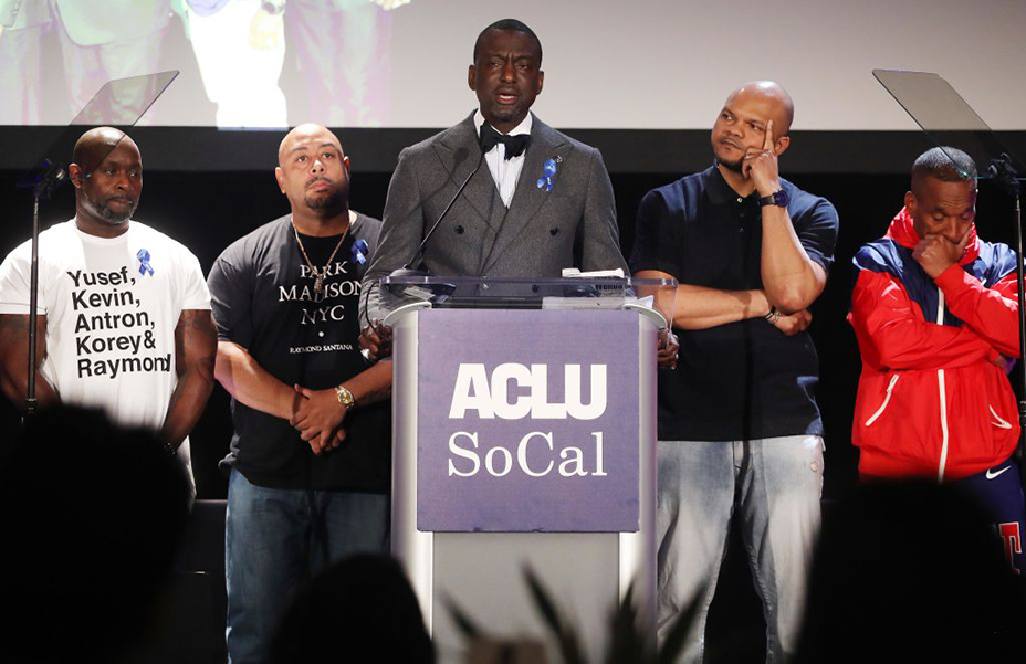 Five Black men on stage at an ACLU awards luncheon.