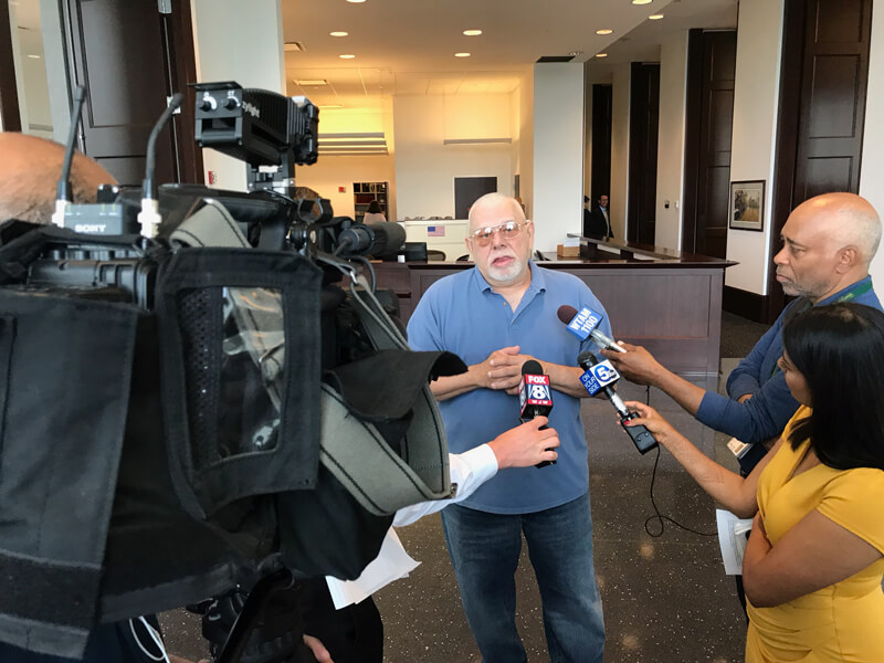 Photograph of Phil Nichols of Cincinnati, Ohio, talking to reporters in 2018. His father, Robert Ivan Nichols, abandoned the family in the 1960s and soon ceased all contact. Genetic genealogy revealed his final fate: Robert Ivan Nichols was an unidentified man who had committed suicide in 2002 in an Eastlake, Ohio apartment and had been living under a stolen identity for decades.