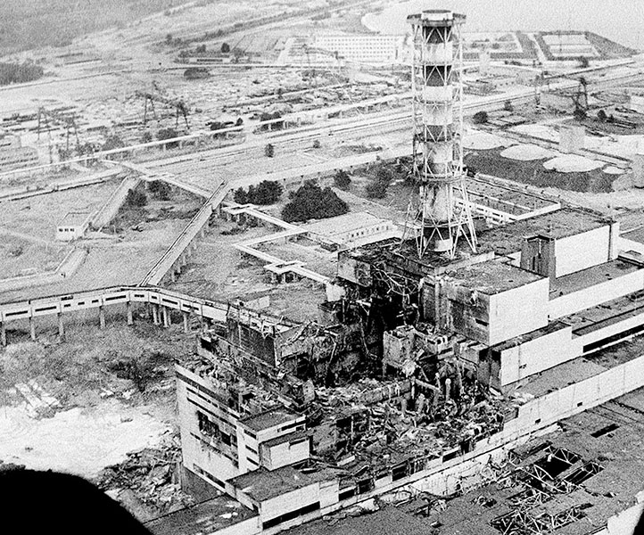 Black and white photo of the ruined nuclear reactor at Chernobyl, taken shortly after the accident.