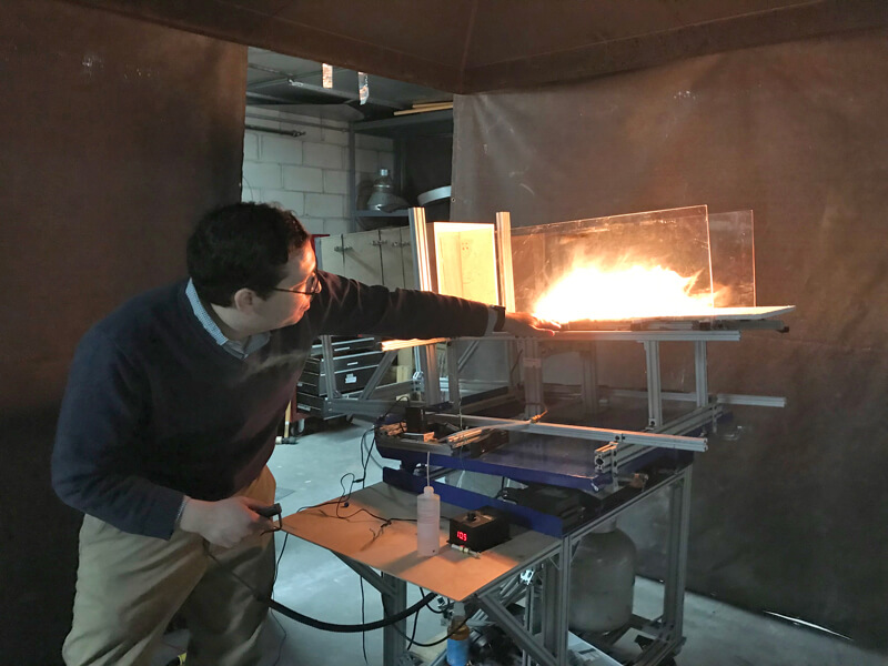 Photo shows one of the experiments Michael Gollner does in his lab in his studies of the physics of fire.