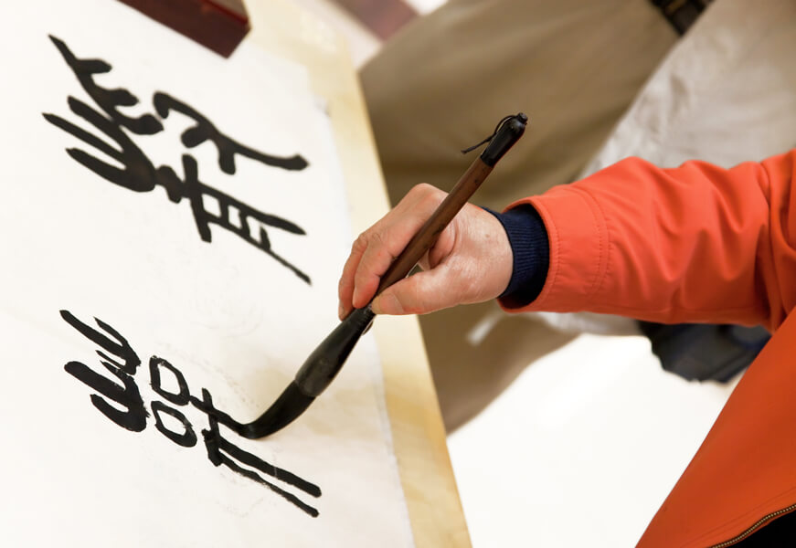 Photo of a hand doing Chinese calligraphy