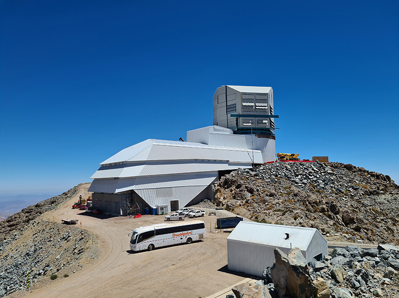 Photo shows the large summit facility building housing the telescope being built atop a mountain near Cerro Pachón, Chile.