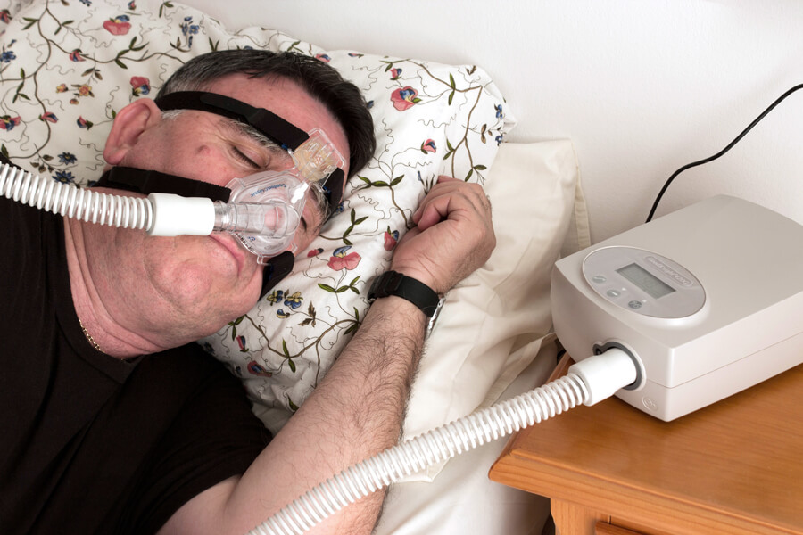 Man wearing CPAP machine as he sleeps