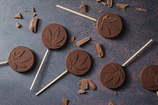 Photograph of chocolate lollipops imprinted with a marijuana leaf. 