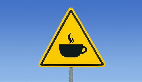 Conceptual warning sign with image of a cup of coffee on it