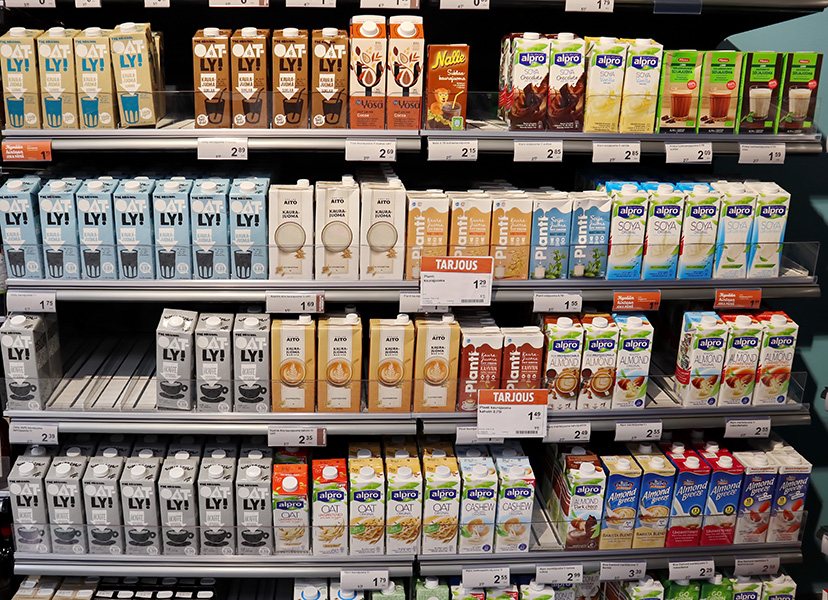 An array of plant-based milks in a supermarket refrigerator case in Finland.
