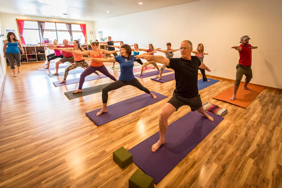 Photograph of people in a yoga class.
