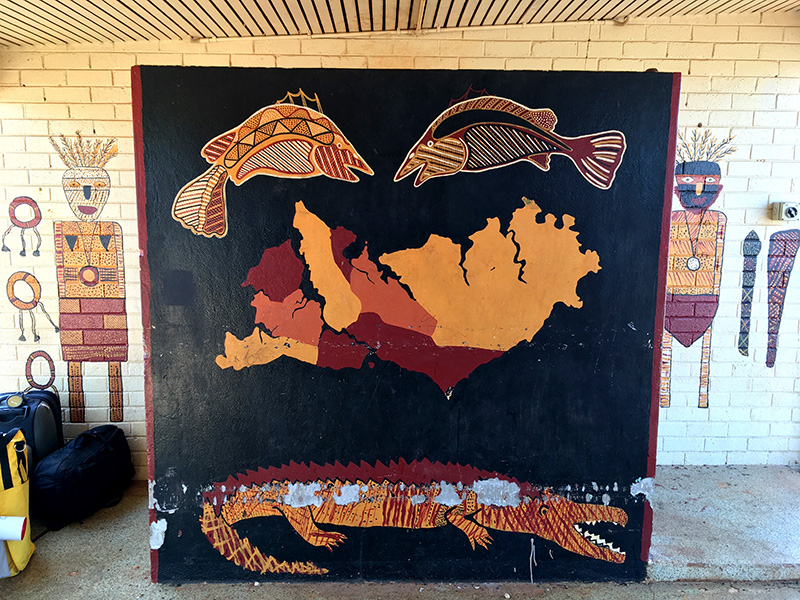 Photograph of Indigenous art depicting islands and fish and crocodiles.