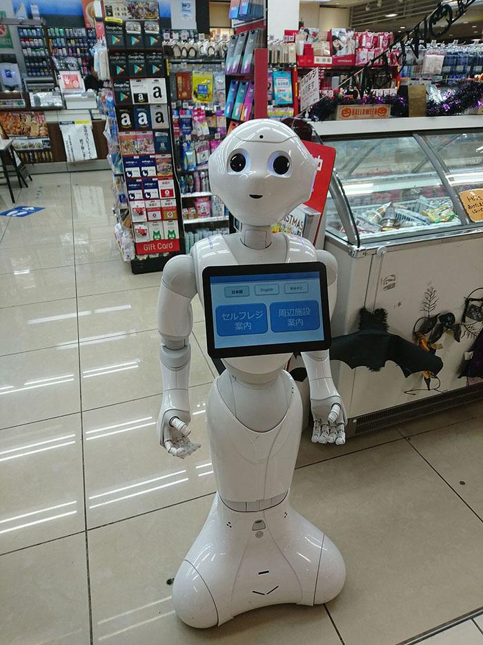 Pepper, a humanoid robot, stands in a convenience store.