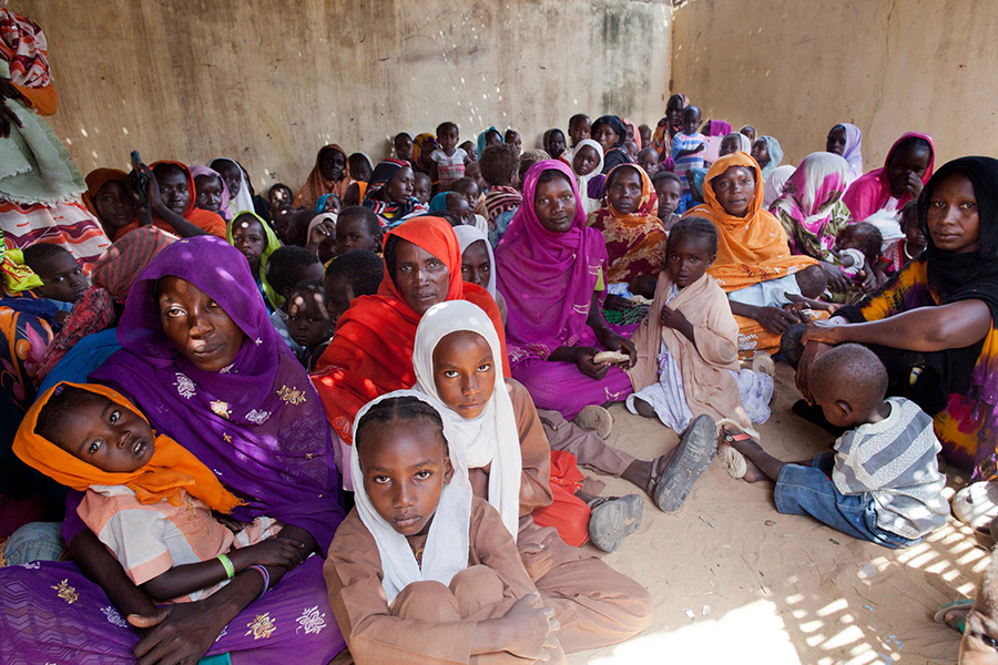 A room full of women and children wait to be vaccinated against meningitis in a refugee camp in Darfur.