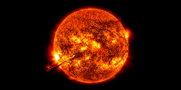 Composite mage shows a solar filament that ribbons from a glowing red sun with areas of yellow eruptions against a black sky.