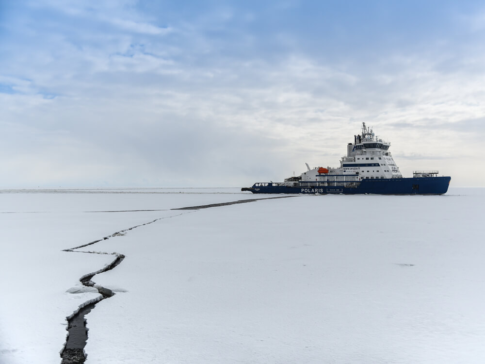 An icebreaker ship makes its way through Arctic sea ice