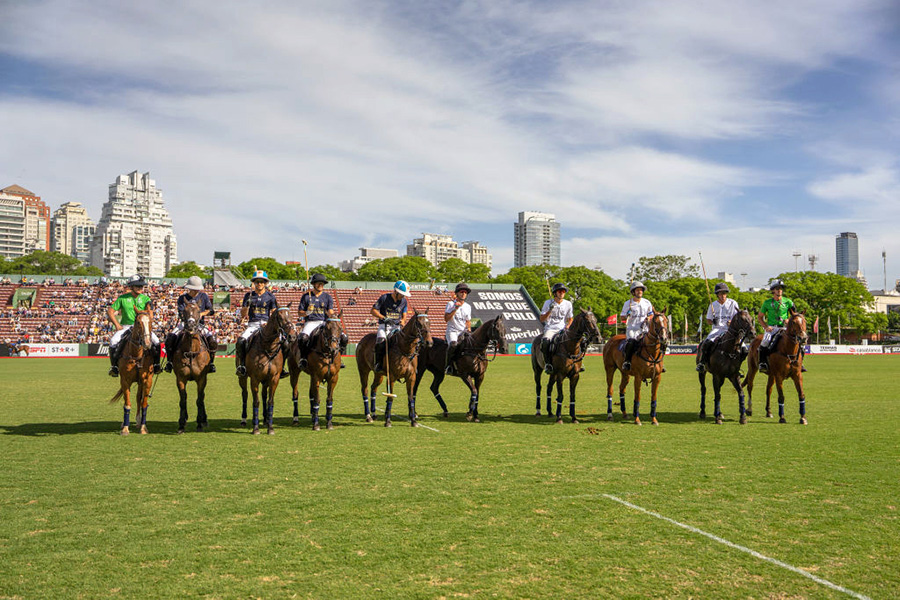Cloned polo horses at a tournament Ten horses with their riders lined up on a polo field.