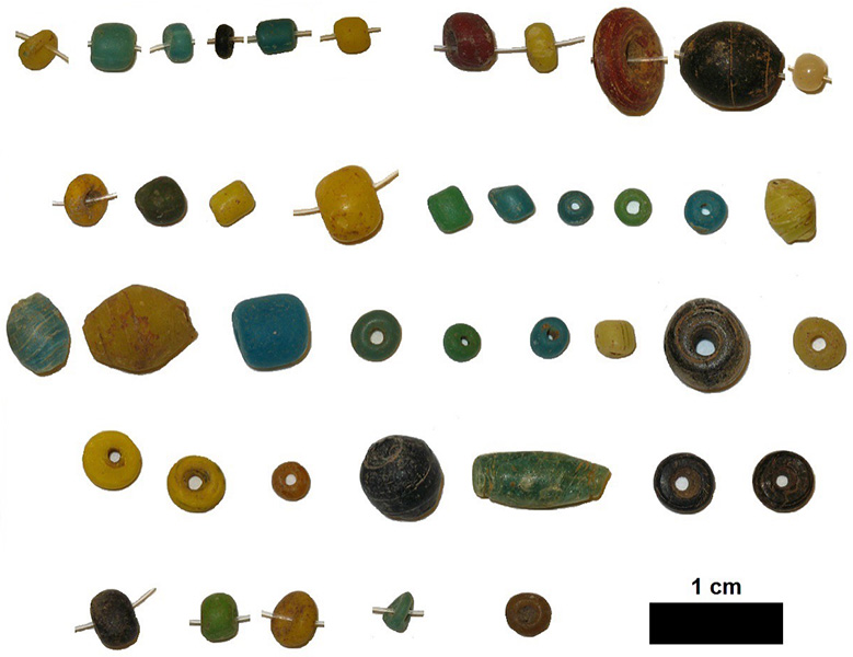 Evidence of technology and trade Glass beads in various colors on a white background.