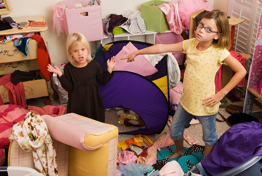Accusation Two young girls in a bedroom, one pointing at the other in an accusing gesture.