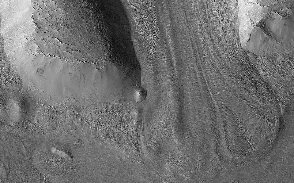 An image captured by the Mars Reconnaissance Orbiter and the High Resolution Imaging Science Experiment (HiRISE) shows a mass of material that seems to have flowed downhill, forming a valley that resembles Earth’s glacial valleys.