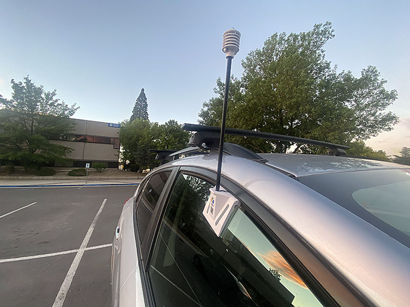 Photo shows a small device sticking up from a car window.