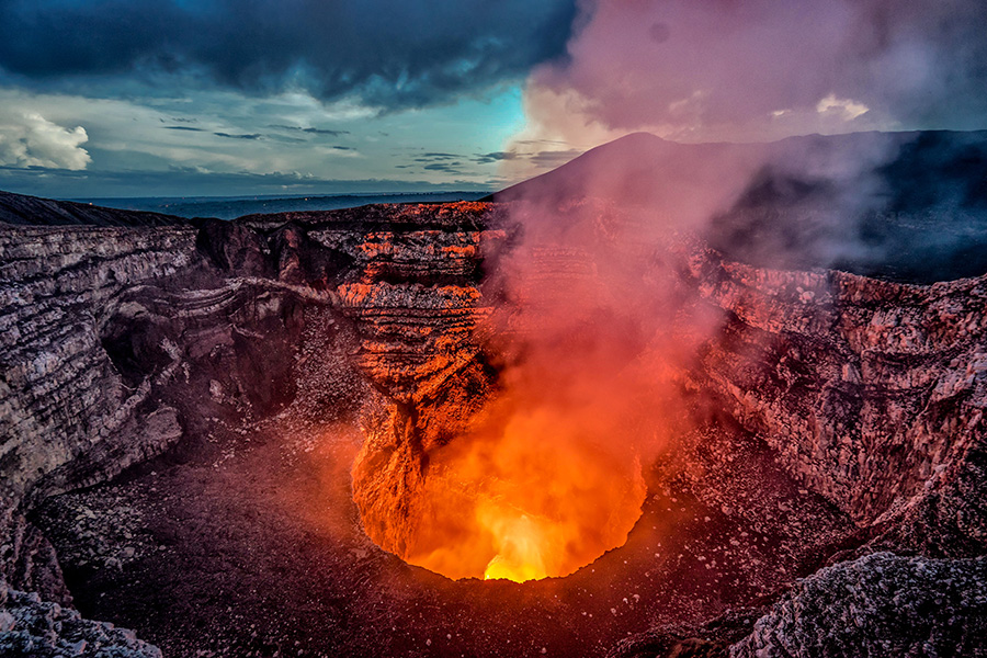 Crater of a volcano showing incandescent lava.